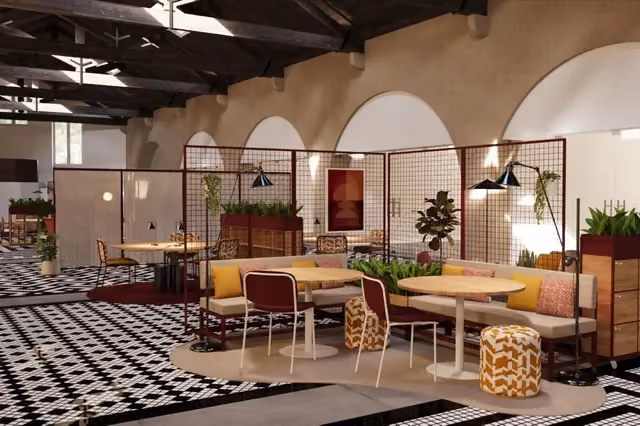 Zona de lounge do coworking Dehouse, com bancos corridos, mesas redondas, plantas e arcos ao fundo